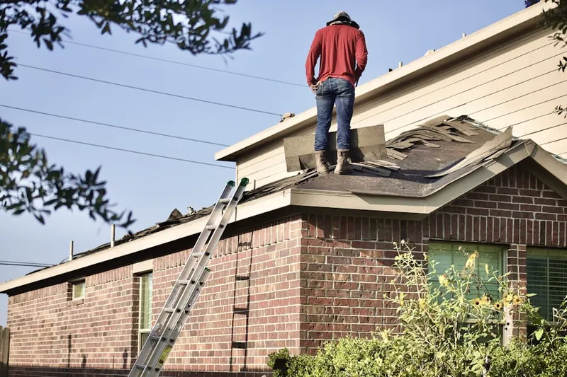 Professional roofer working on a residential roof in Smith City